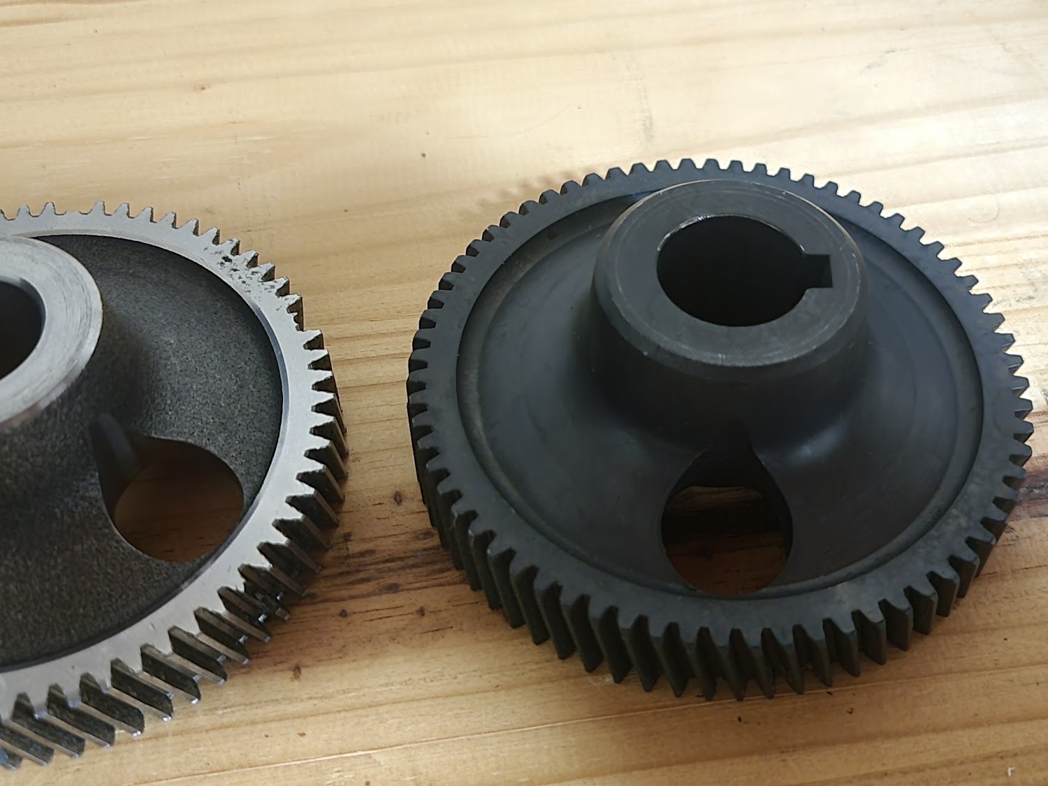 Original worn gear alongside a newly manufactured replacement gear